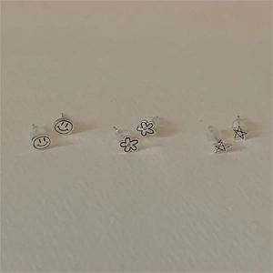 Minimalist 925 sterling silver earring set featuring smiley face, star, and flower studs