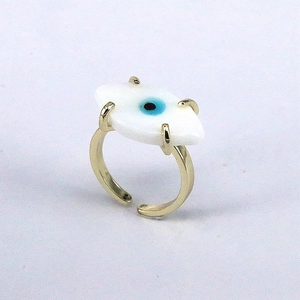 Detail of adjustable gold ring featuring a blue evil eye charm with enamel finish