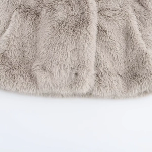 Close-up detail of dense faux fur texture on short light taupe winter coat for women