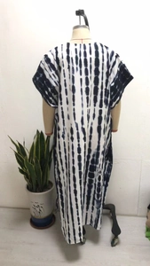 Detail of blue and white tie-dye striped knit beach cover-up with breathable fabric