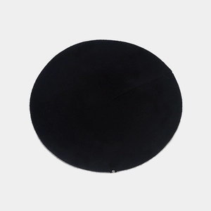 Detailed top view of a black wool beret showing premium texture and classic round shape