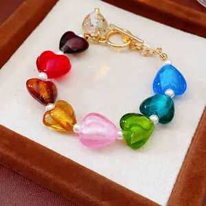 Colorful glazed heart bead bracelet with white pearls and a golden toggle clasp