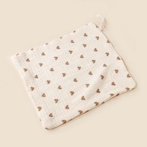 Soft muslin cotton baby washcloth with brown heart patterns and hanging loop.