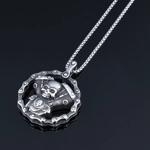 Detail of gothic stainless steel skull engine pendant with mechanical chain elements