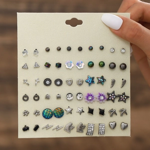 Macro shot of a 30-pair stud earring set featuring bows, flowers and starfish designs