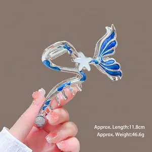 Large mermaid tail hair claw in silver metal with deep sea blue enamel and star detail
