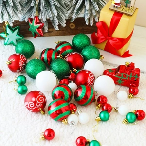 Detailed view of red, green and white Christmas balls on a white faux fur rug for festive decor