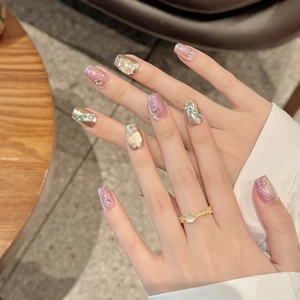 Handmade cat eye press-on nails with golden metallic finish and sparkling crystals