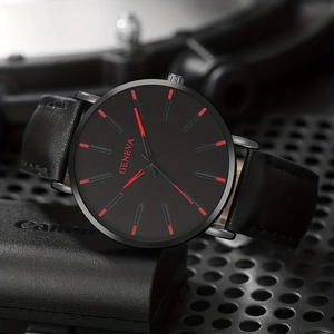 Detail view of black dial quartz watch with red indices and premium leather strap