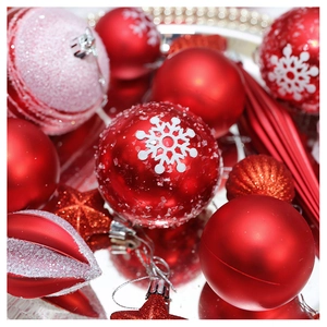 Macro detail of red Christmas ornaments with snowflake patterns and glitter finishes