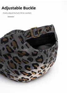 Detail of adjustable bronze metal buckle on vintage leopard print canvas baseball cap