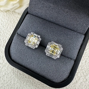 Macro view of square yellow sapphire earrings with halo diamonds in velvet box
