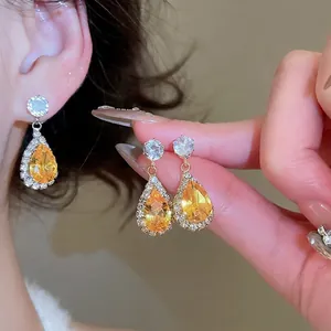 Vintage golden teardrop earrings with sparkling zircons and elegant palace style design