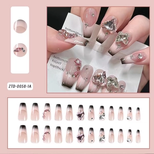 Detail of pink gradient press-on nails with heart rhinestones and bows, model ZTD-0058-1A