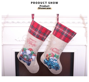 Detail of Christmas stockings with gnome truck print and red buffalo plaid cuffs