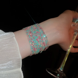 Close-up of sparkling blue and pink rhinestone multi-layer wrap bracelet on model wrist