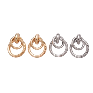 Geometric interlocking round metal hoop earrings in gold and silver finish with texture