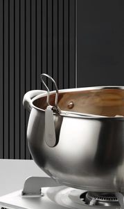 Close-up of 304 stainless steel strainer hook hanging securely on a hot pot edge