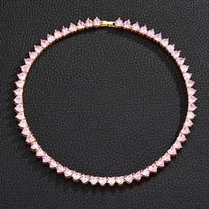 Close-up of pink heart-cut gemstone tennis necklace in gold setting on black leather