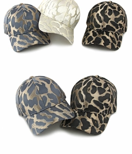 Close-up of jacquard leopard baseball caps with shimmering metallic thread texture