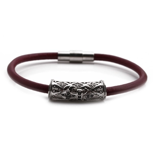 Close-up of deep red leather bracelet with engraved silver tube and magnetic clasp