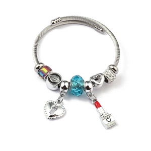 Detailed view of stainless steel charm bracelet with blue crystal and heart lock pendant