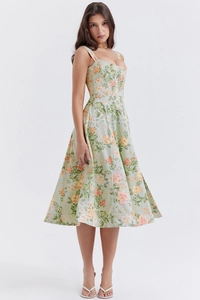 Detailed close-up of floral print and corsetry structure on a green midi summer dress