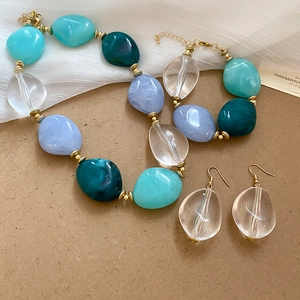 Detailed view of acrylic oval beaded jewelry set with necklace bracelet and earrings