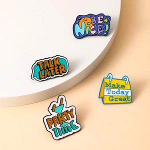 Set of four colorful enamel lapel pins with social quotes on a minimalist round stand