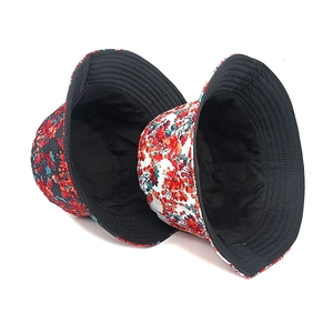Double-sided floral bucket hats in black and white with sun protection for outdoors