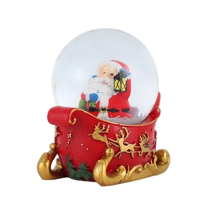 Detailed view of Santa in a red sleigh with golden reindeer patterns on Christmas snow globe