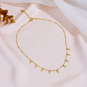 Gold minimalist stainless steel necklace with small cross pendants on a fine chain link