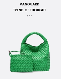 Detail of green woven leather hobo bag and small pouch set with classic intrecciato texture