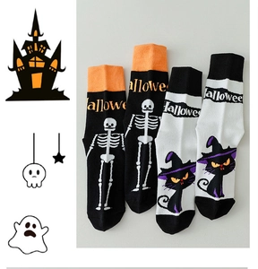 Detail of Halloween crew socks featuring skeleton and black cat patterns in orange and black