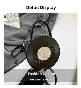 Detail view of the black vinyl record shoulder bag with musical elements and metal zipper