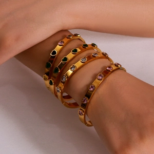 Gold stainless steel heart bracelets with colorful zircon stones worn by model