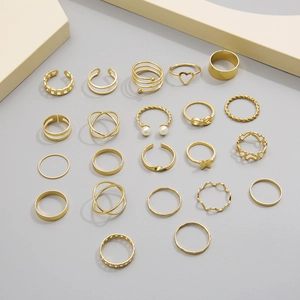 Flat lay of 19 pieces gold ring set with heart, pearl and hollow leaf geometric designs