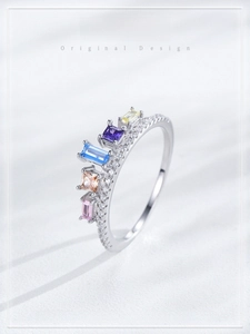 Macro shot of silver crown ring with colorful cubic zirconia and shimmering small diamonds
