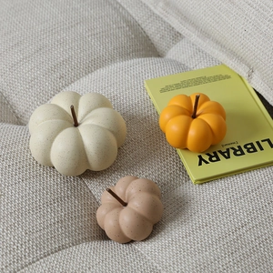 Set of three ceramic pumpkin home decorations in white, orange, and brown for living room