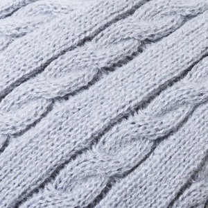 Close-up of winter cable knit hat in light grey blue with soft thermal lining texture