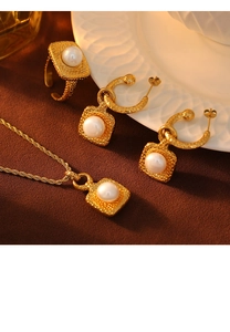 Detail of vintage French gold square hammer textured jewelry set with white pearls