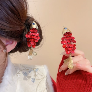 Detail of red fish hair clip with gold fringe and blue pearl on koi carp jewelry