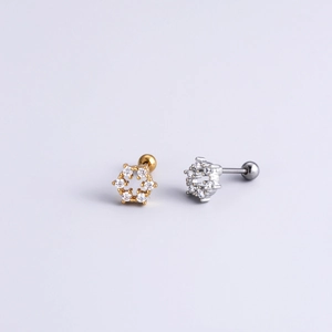 Macro detail of hexagonal screw back ear studs in gold and silver finish with zircon