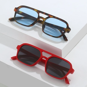 Square double-bridge sunglasses in tortoiseshell and red frames on white props