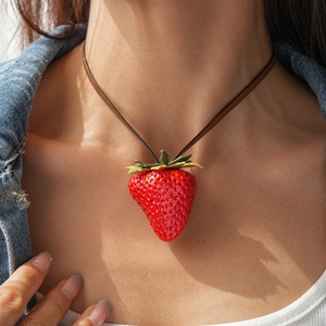 Realistic strawberry pendant necklace with red resin and leather cord on a female model