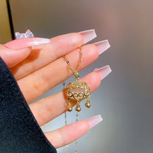 Titanium steel gold necklace with hollow Ruyi lock pendant and dangling beads detail