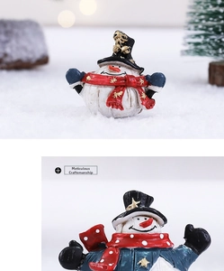 Close-up showing the hand-painted texture and fine details of resin snowman figurines