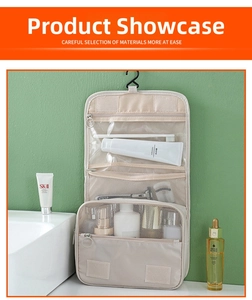 Detail view of cream hanging toiletry bag with PVC pockets and breathable mesh compartments