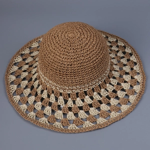 Detailed view of the hollow-out diamond crochet pattern on a wide brim straw sun hat
