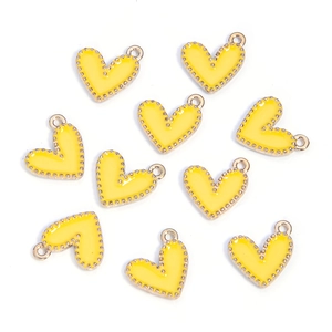 Macro view of 10-piece yellow enamel heart charms with gold-plated alloy edges